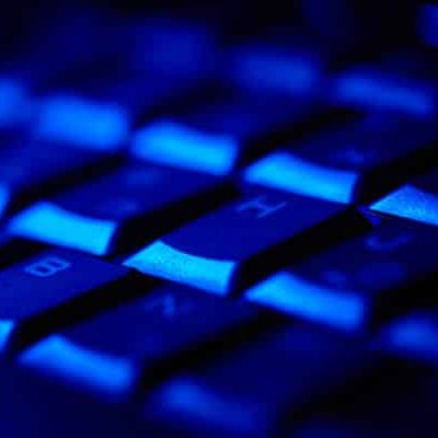 Computer keyboard in blue light. Small depth of field.