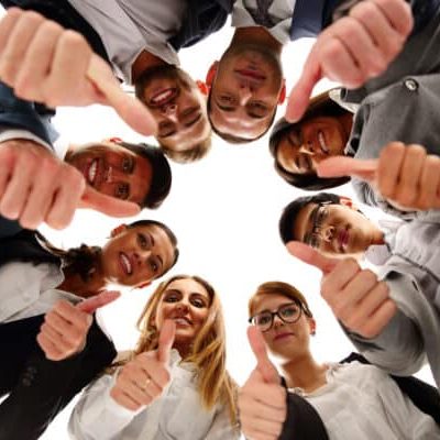 Group of business people standing in circle, with thumbs up