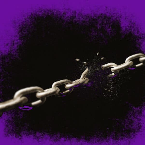 A chain on a black background breaks